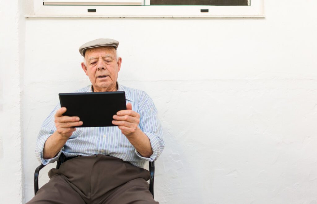 elderly man is using a tablet in the yard of his h 2022 05 09 23 11 56 utc