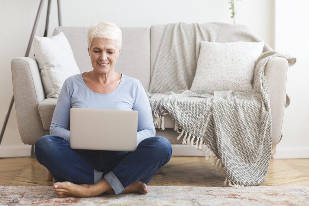 resourceful mature woman sitting on floor and usin 2022 10 07 02 34 37 utc